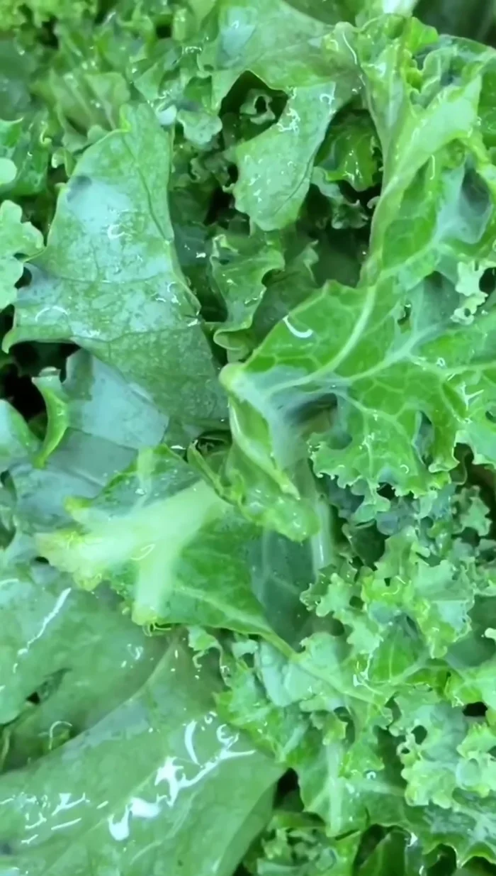 Add the kale or collard greens to the pressure cooker.