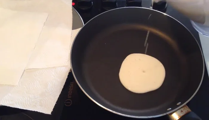 Pour a small amount of batter onto the hot pan to make pancakes of your desired size.