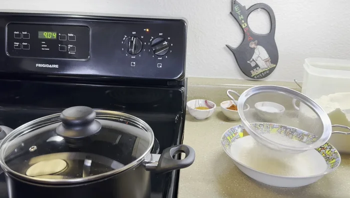 Start by combining the Gebse (teff flour) and water in a pot. The amount will depend on your desired consistency.