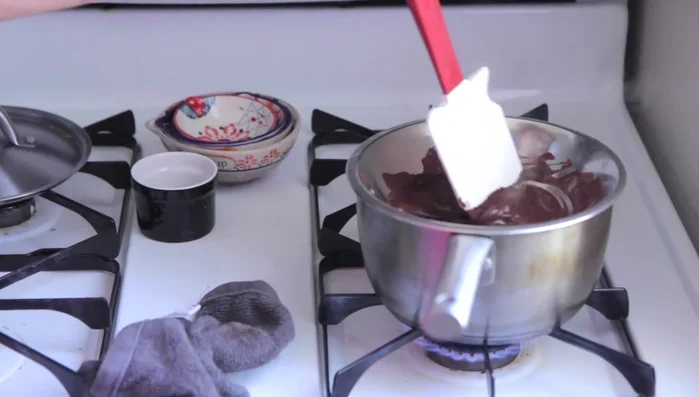 Add the espresso beans to the chocolate mixture and coat them evenly.