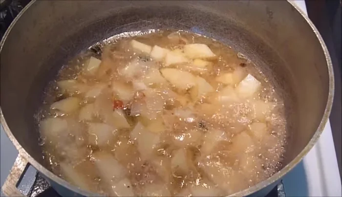 Add amaranth leaves, spices (onion powder, garlic powder, cayenne pepper, salt), and basil to the pot.