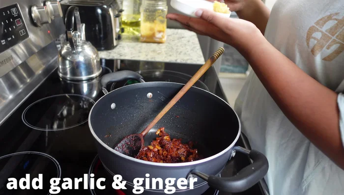 Add the blended ginger and garlic mixture to the pot.