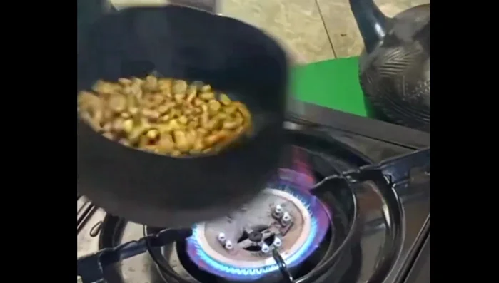 Roast the beans on a portable gas stove until they are dark brown and oily. The whole house will smell amazing!