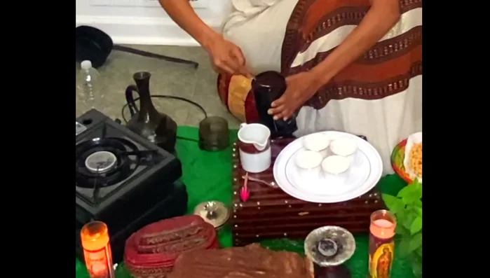 Add the ground coffee to the Jebena. Add about half a bottle of water, stir, and then pour into the Jebena.