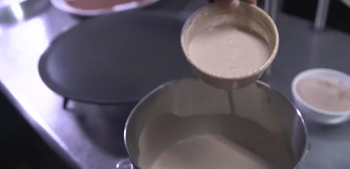 Mix teff flour (and optional wheat flour) with water to create a batter. (Note: The recipe uses a mix of teff and wheat flour for cost-effectiveness. Pure teff is also an option.)