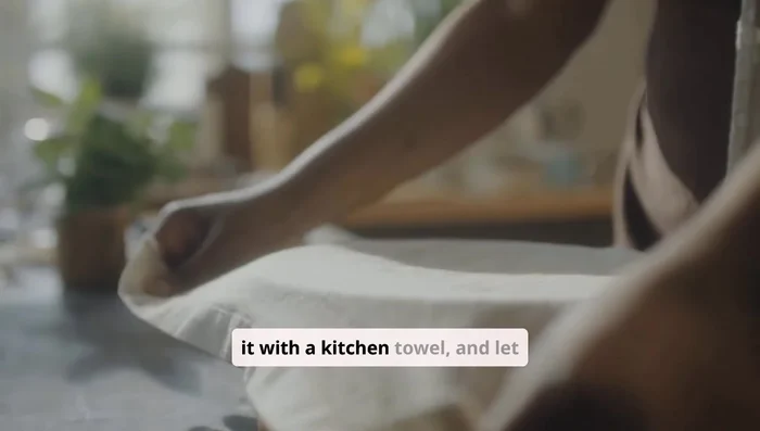 Place your dough in a greased bowl. Cover it with a kitchen towel and let it rise in a warm place for about an hour until it doubles in size.