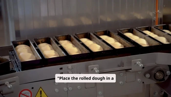 Place the rolled dough in a greased loaf pan. Cover it again and let it rise for another 30 to 45 minutes.