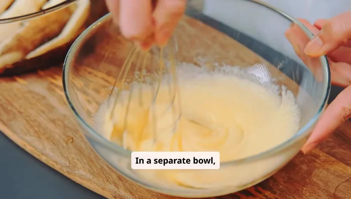 In a separate bowl, whisk the warm milk, egg, and melted butter. Slowly pour the wet ingredients into the dry and mix until it forms a dough.