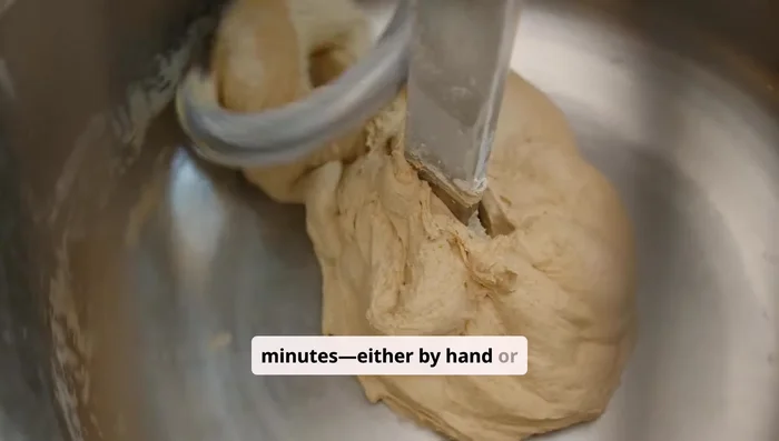 Knead the dough for about 8 to 10 minutes, either by hand or using a mixer with a dough hook, until it's smooth and stretchy.