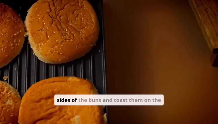 Lightly butter the cut sides of the buns and toast them on the skillet or grill until golden brown. This adds flavor and prevents sogginess.
