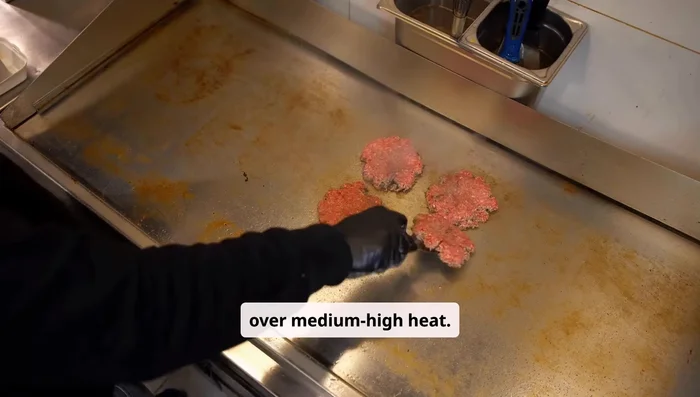 Heat a skillet or grill over medium-high heat. Cook the patties for about 3 to 4 minutes per side, or until they reach your desired doneness. Add a slice of cheese during the last minute of cooking to melt.