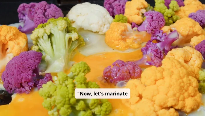 Marinate the cauliflower: Combine cooled cauliflower with lemon juice, Kashmiri chili powder, breadcrumbs, rice flour, and baking powder. Mix well. Optionally, add ginger garlic paste, garam masala, and chopped curry leaves.