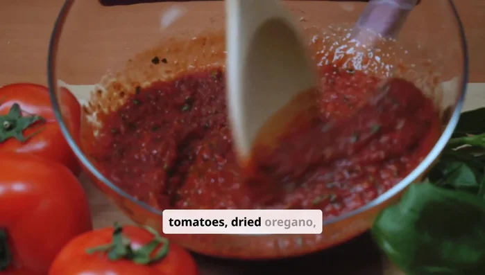 While the dough rises, mix crushed tomatoes, oregano, garlic powder, salt, and pepper in a bowl. No cooking needed.
