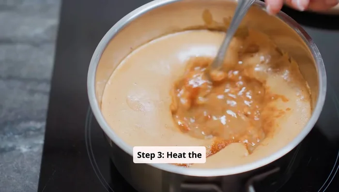 Heat the mixture: Place the saucepan over low heat. Let the mixture warm gently for about 10 to 15 minutes. Do not boil.