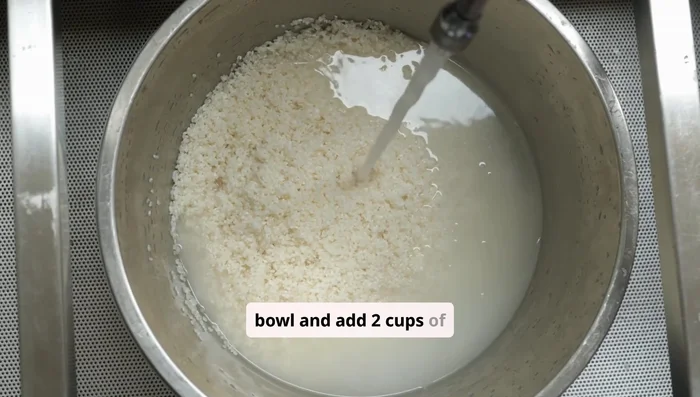 Place the rinsed rice in a bowl and add two cups of water. Let it soak for about 30 minutes to 2 hours to allow the nutrients to infuse into the water.
