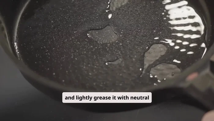 Preheat a non-stick pan over low heat. Lightly grease with oil. Scoop batter onto the pan to form tall mounds (three scoops per pancake). Add water to the pan to create steam, cover, and cook for 6-7 minutes.