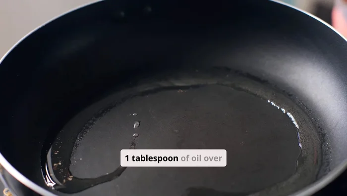 Heat 1 tbsp oil in a pan. Add finely chopped garlic and ginger; sauté until golden (about 1 minute).