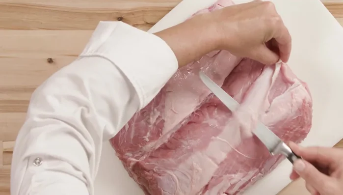 Trim and French the veal rack. The fresher the veal, the easier it is.
