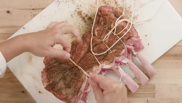 Tie between each rib to maintain shape. Cover bone ends with foil to prevent burning. Marinate for about 20 minutes.