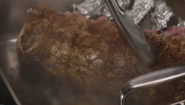 Sear the rack in a roasting pan until browned. Then place in a 350-degree oven, turning occasionally, until the internal temperature reaches 135 degrees (about 35-45 minutes).