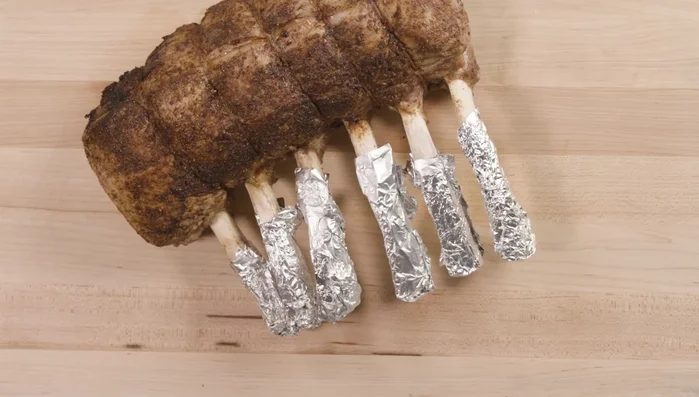 Let the veal rest for 10 minutes. Remove foil and twine, then slice between the bones.