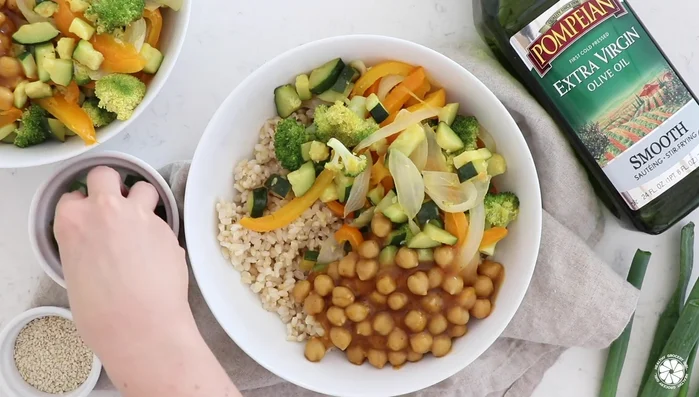 Serve the sautéed vegetables over rice with the orange ginger chickpeas. Garnish with sesame seeds and green onion.