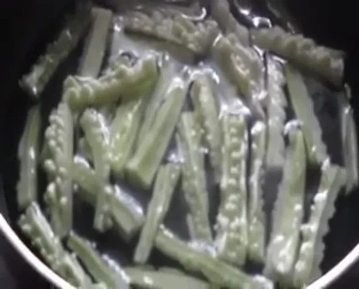 Slice bitter gourd into long, slender pieces.
