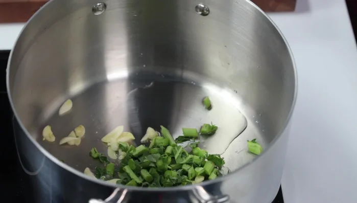 After a few minutes, add all the kale leaves to the pot.