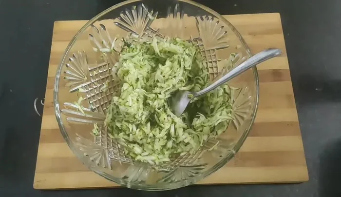 Grate the zucchini and squeeze out excess water. Keep aside for 10 minutes.