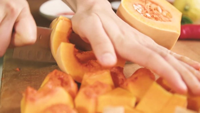 Chop up pumpkin or butternut pumpkin. When roasting, you don't need to peel the skin; it adds fiber and becomes tender when roasted.