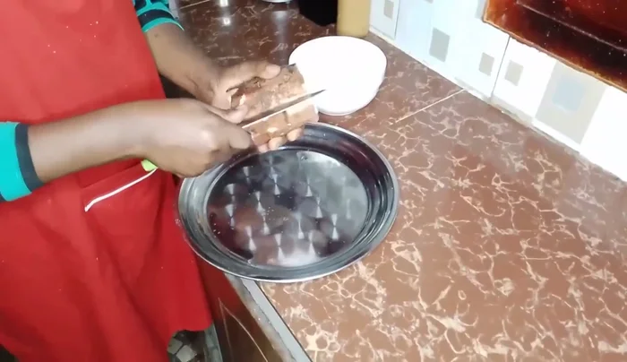 Peel the cassava. Make a line across and twist the knife to easily remove the peel.