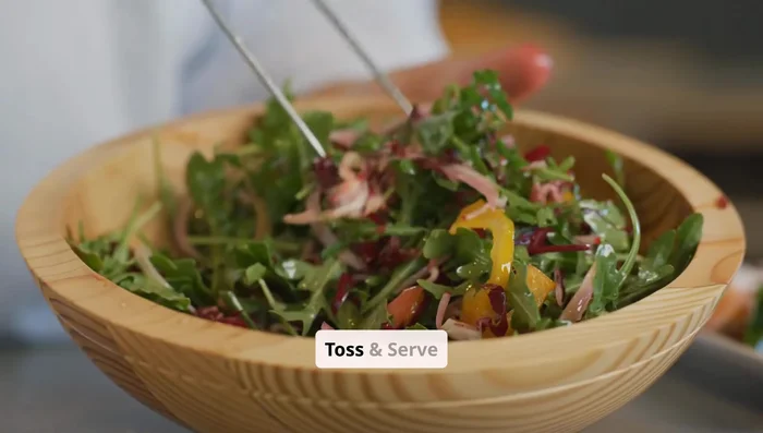 Gently toss to coat, leaving the feta slab untouched.
