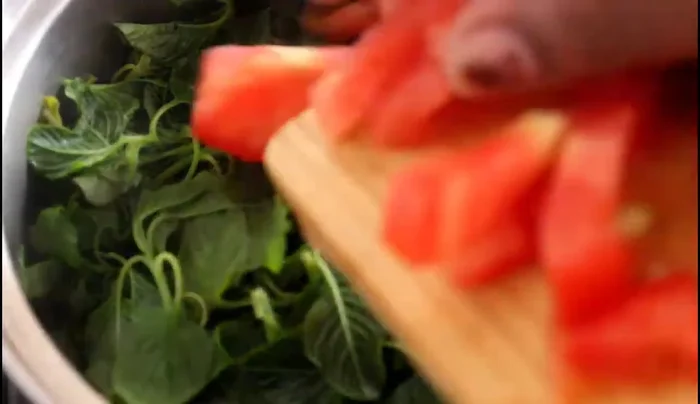 Once the vegetables are cooked, add the chopped tomatoes to the pot.