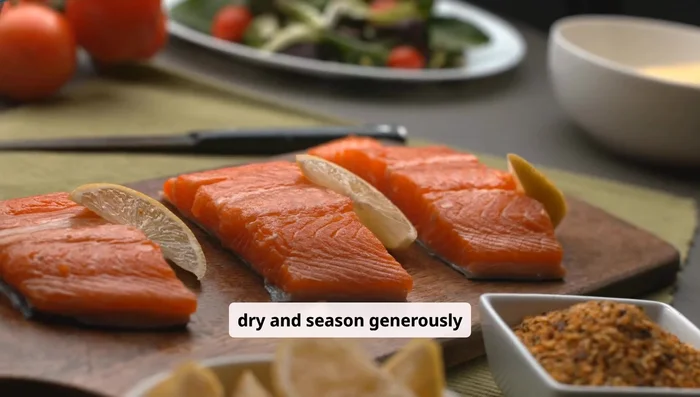 Pat salmon dry and season generously with salt, pepper, garlic powder, and smoked paprika. Drizzle with olive oil.